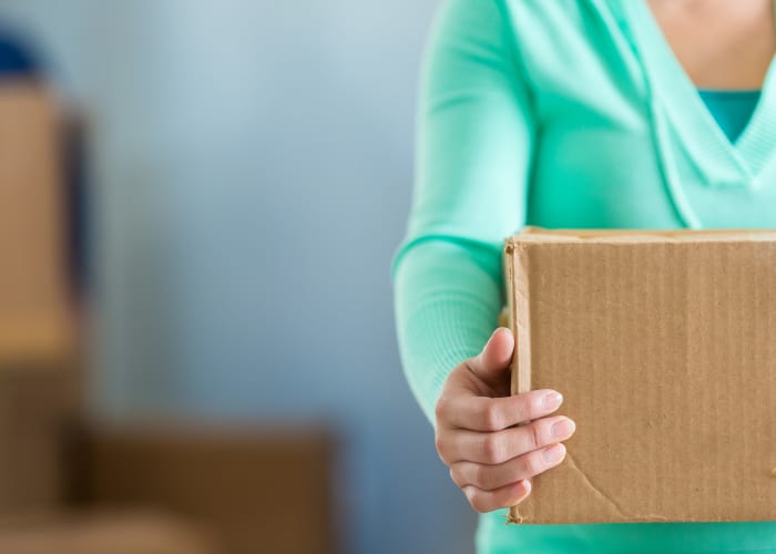 Woman holding a box at Squirrel Storage Ames in Ames