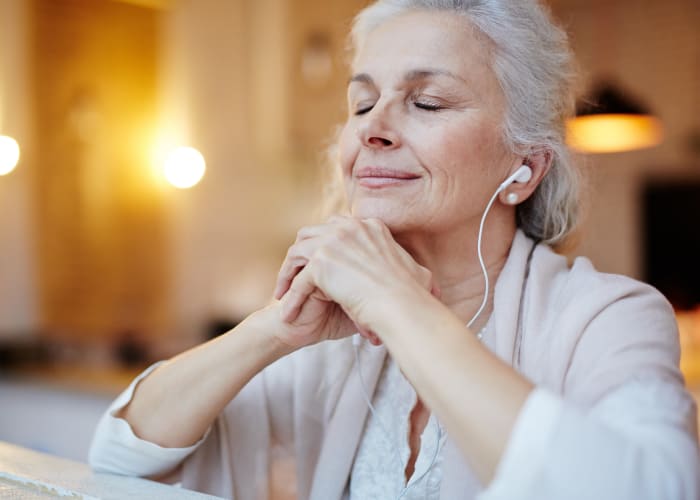 A resident relaxing with headphones at Westminster Memory Care in Lexington, South Carolina