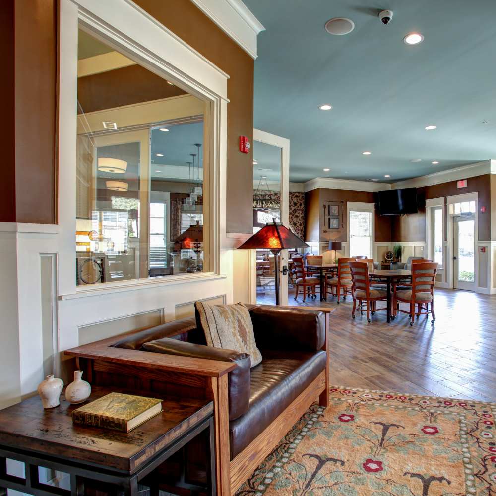 Inviting common area featuring a cozy leather sofa and rustic decor at Avonlea Square in Smyrna, Georgia.