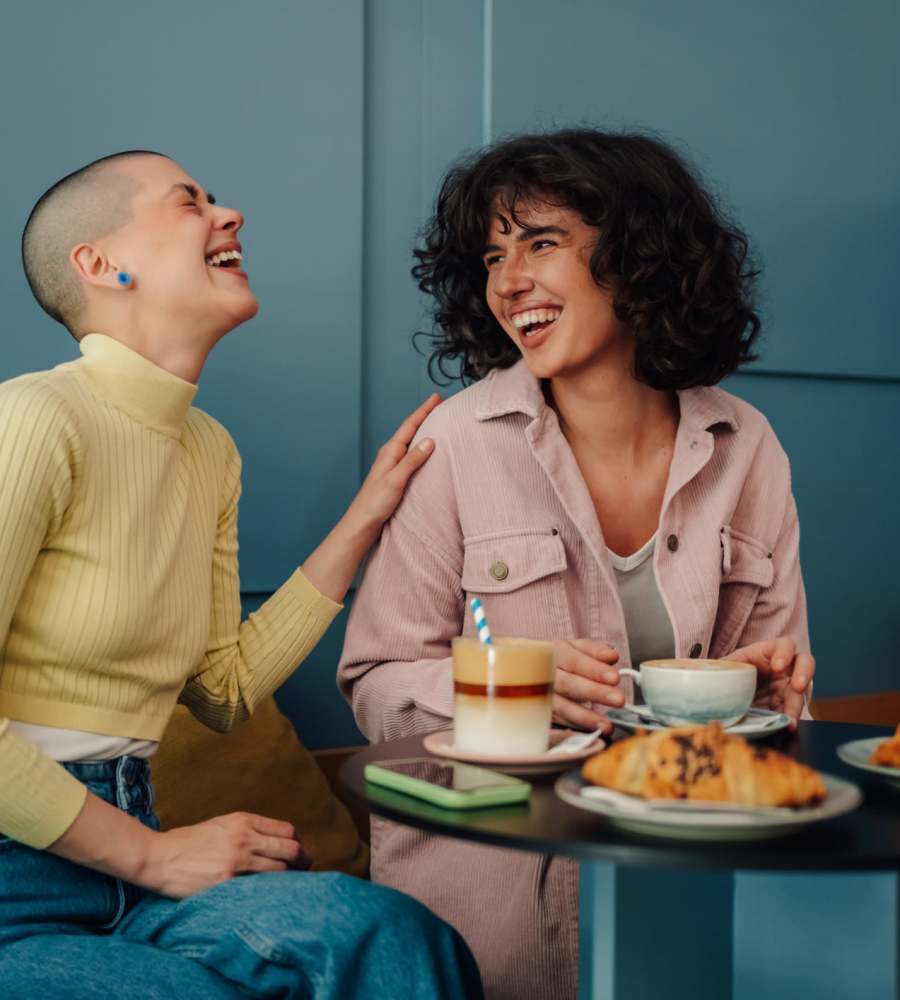 Two friends enjoying a meal in a cafe near Parkwood Oaks in Bedford, Texas