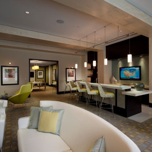 Resident lounge with a large flatscreen TV, billiards table, and ample seating at Solaire 1150 Ripley in Silver Spring, Maryland