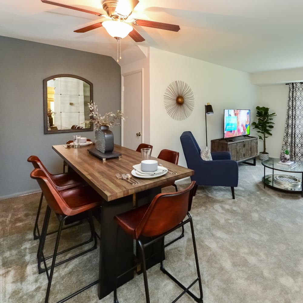 Dining area and living room in an open floor plan model home at Forge Gate Apartment Homes in Lansdale, Pennsylvania