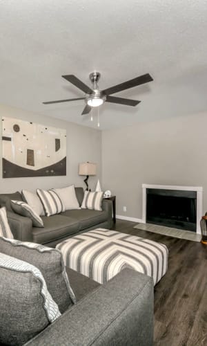 Model living room with fireplace at Rivercrest in Waco, Texas