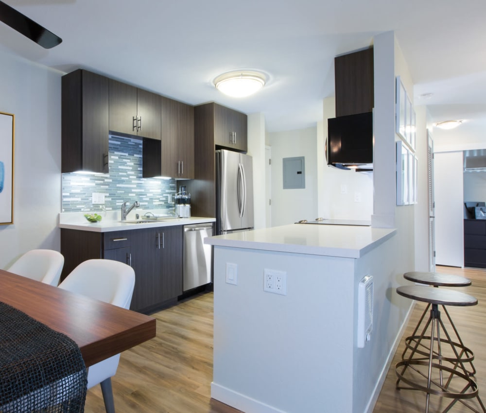 Chef-inspired kitchen with a custom tile backsplash in a model home at Sofi Belmont Glen in Belmont, California