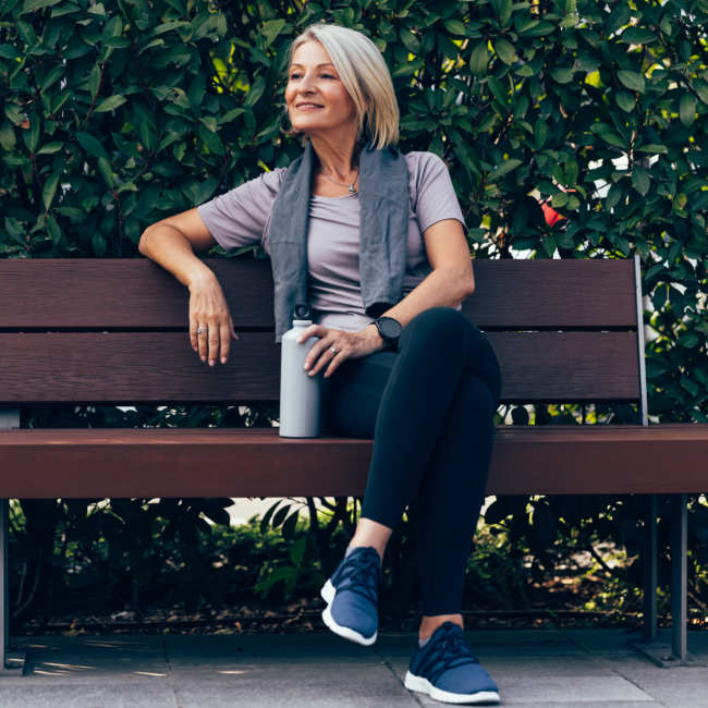 Resident sitting on the bench in the park near Heirloom at Torrey Pines in Las Vegas, Nevada