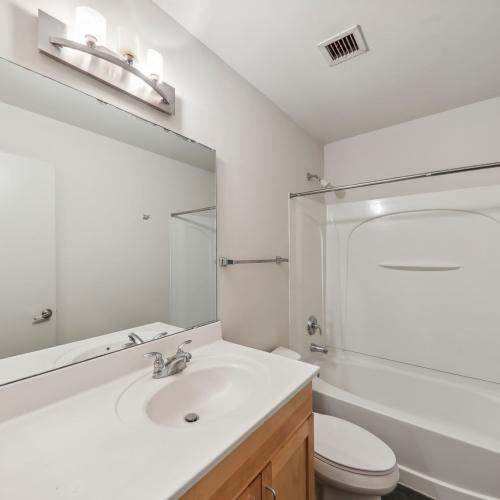 Bathroom with commode and bathtub at Stadium Loft Apartments in Saint Louis, Missouri