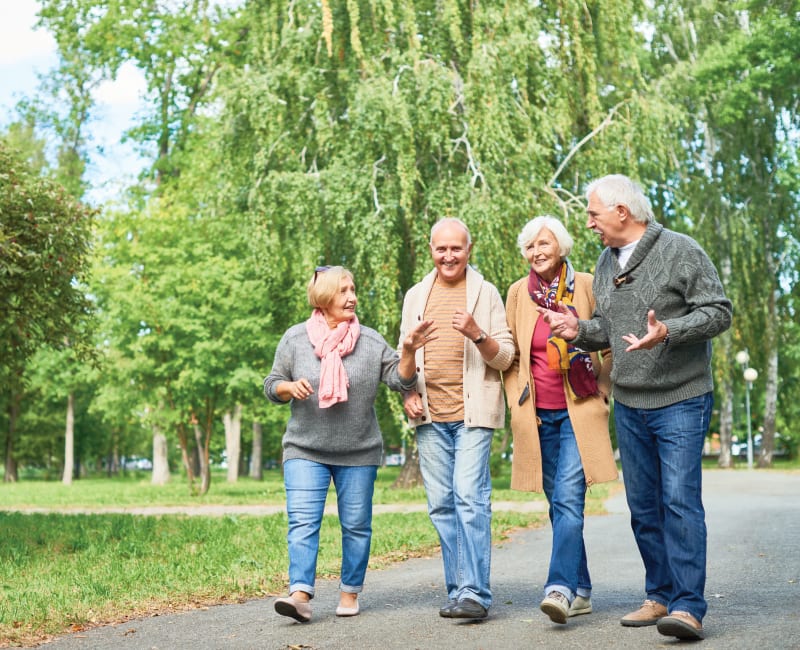 Group of residents walking down a paved path at York Gardens in Edina, Minnesota