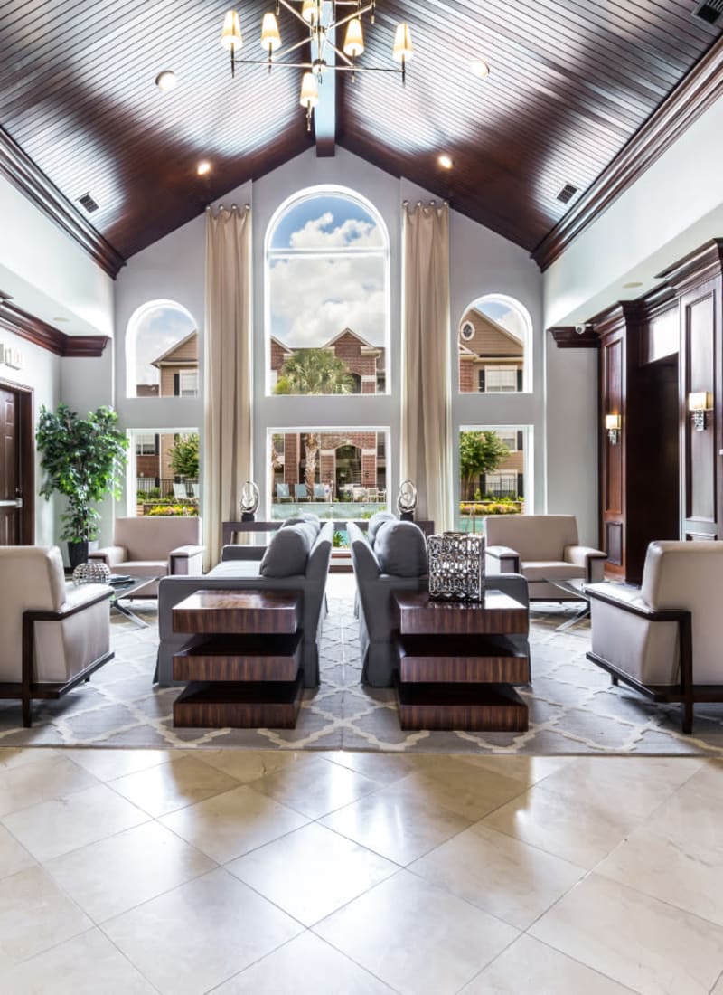 Community clubhouse sitting area with view of pool deck at Marquis on Park Row in Houston, Texas