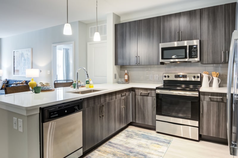 Granite countertops and stainless-steel appliances in a model home's kitchen at Boulders Lakeside in North Chesterfield, Virginia