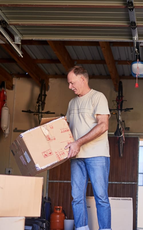 A man organizing boxes at Stor-N-Lok in Springfield, Oregon