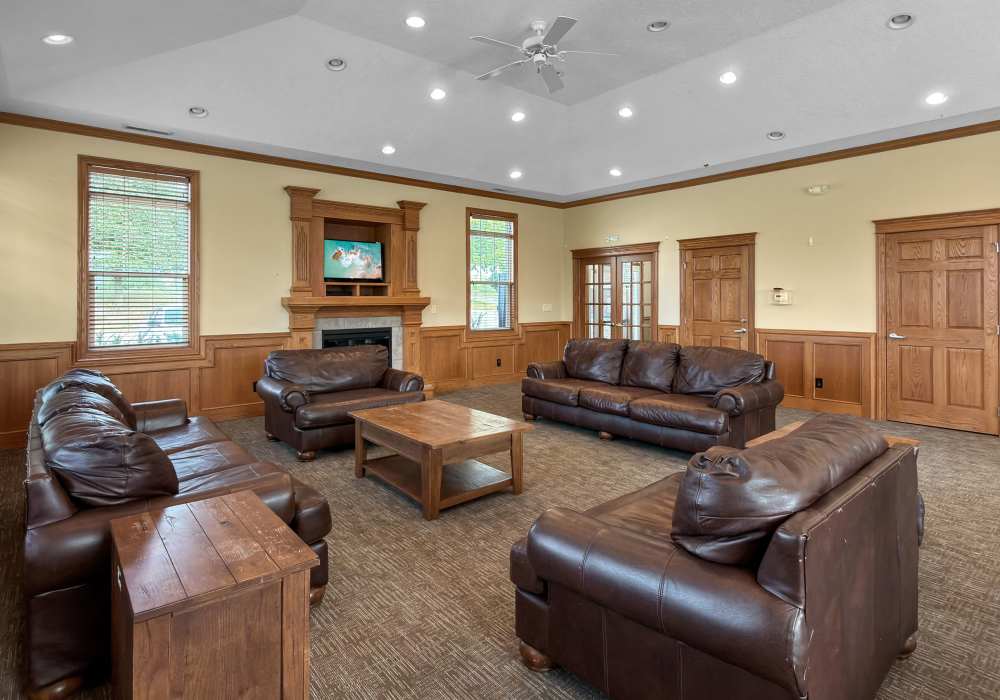 Charming lounge area at Pointe 28 in Ankeny, Iowa featuring cozy leather sofas and elegant wooden accents.