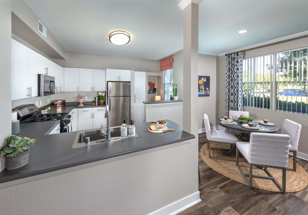 Open kitchen and dining space at Park Hacienda Apartments in Pleasanton, California