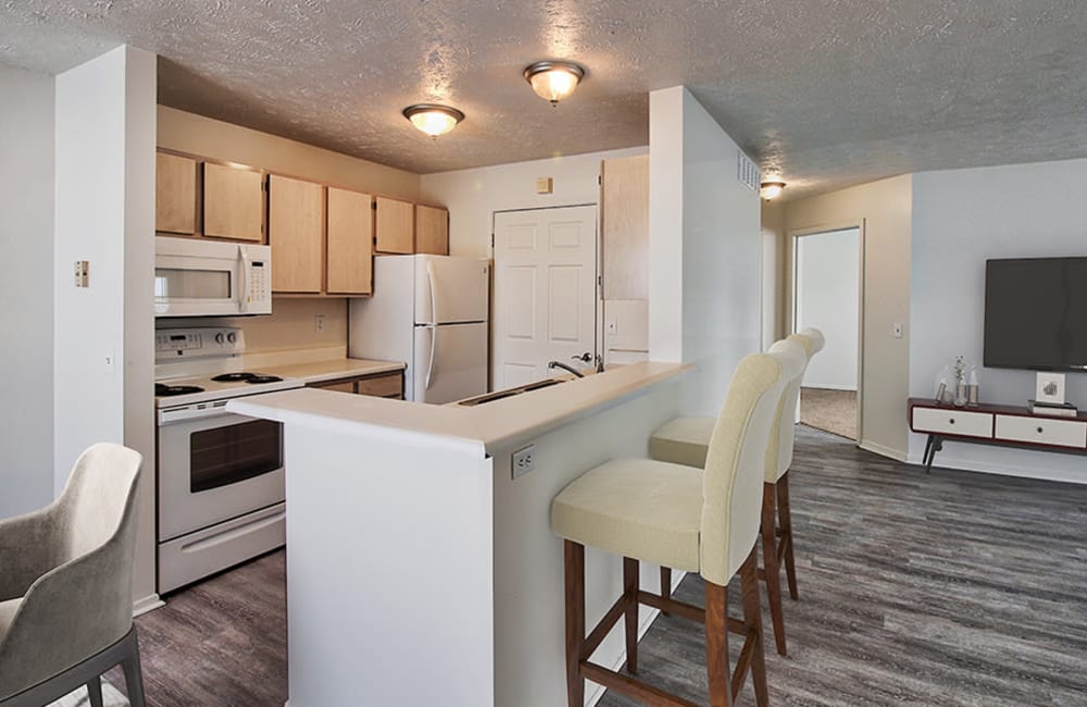 Fully equipped kitchen with a breakfast bar at Westview Commons Apartments in Rochester, New York