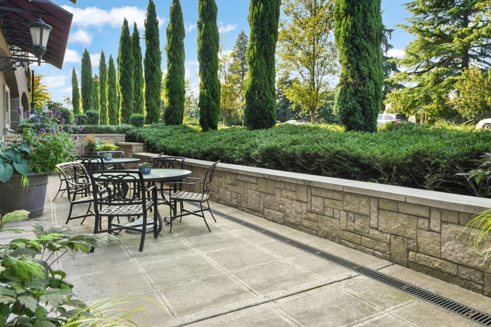 Elegant outside patio area with landscaped trees at The Bellettini in Bellevue, Washington