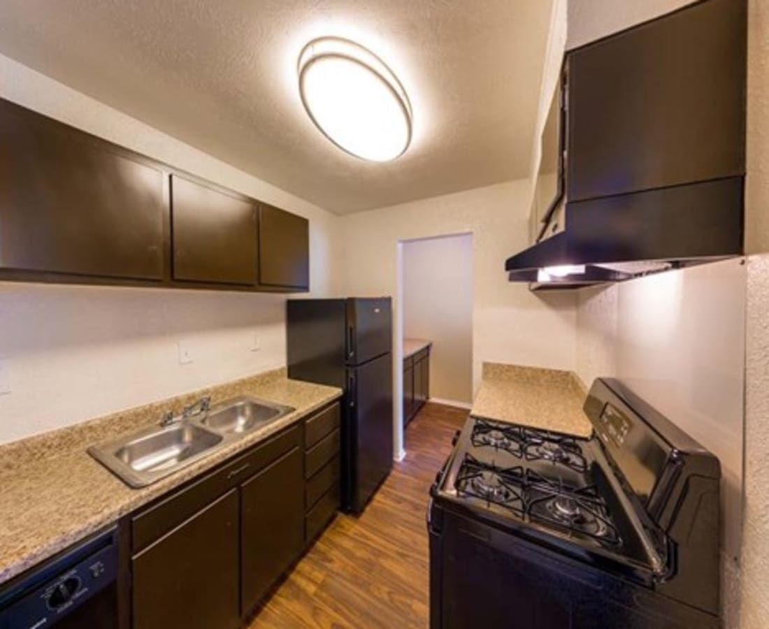 Photo 2 Alt  An apartment kitchen with black appliances at Haven Hill Exchange in Atlanta, Georgia