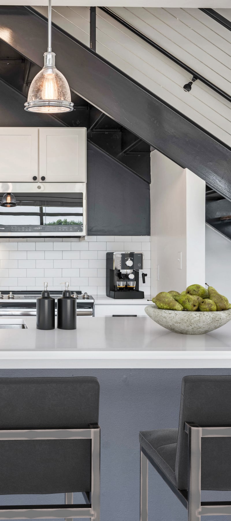 Subway tile backsplash and quartz countertops in a model loft's kitchen at 17th Street Lofts in Atlanta, Georgia