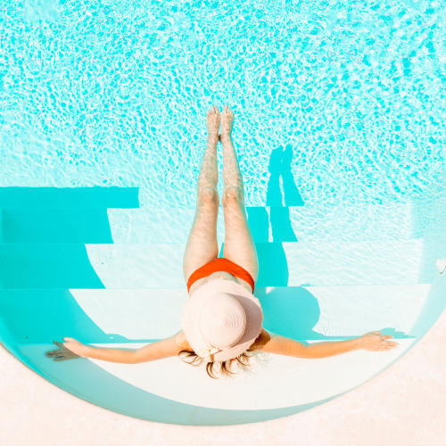 A resident relaxing in a swimming pool at Canyon View in San Diego, California