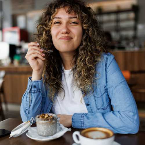 Woman having coffee near Avonlea Tributary in Lithia Springs, Georgia