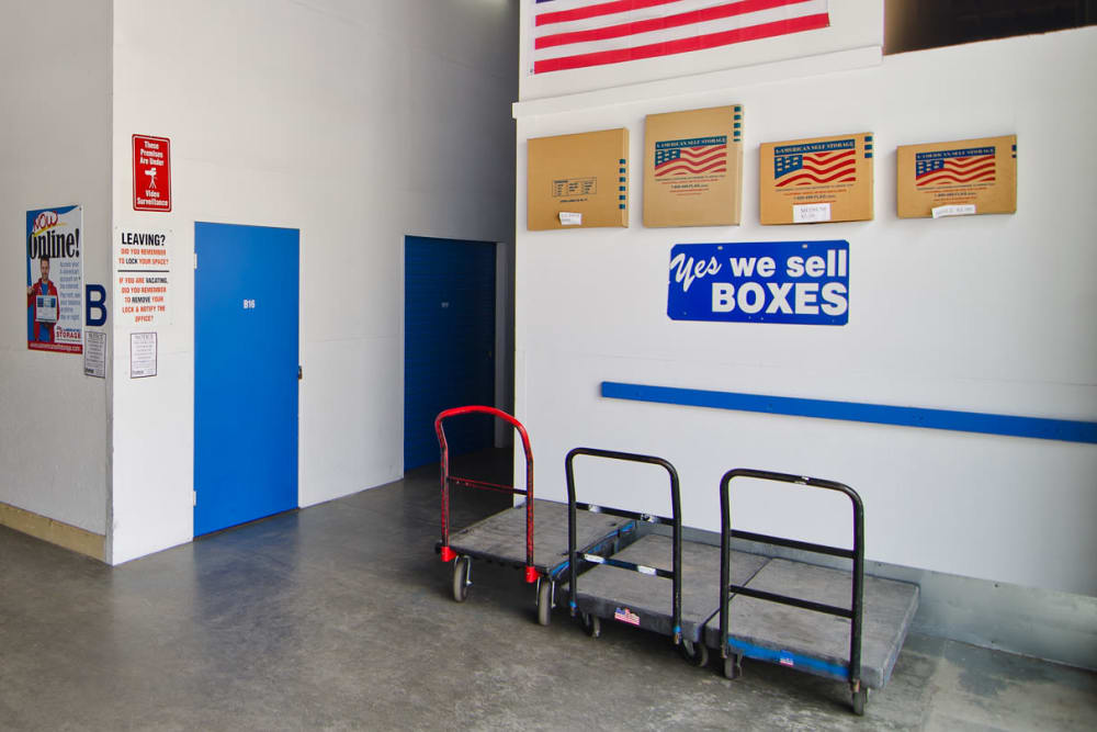 Facility entryway with carts and packing supplies available at A-American Self Storage in Santa Barbara, California