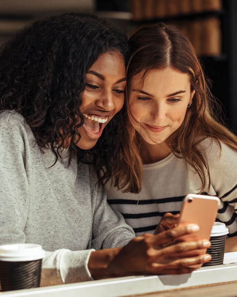 Residents looking at a phone in a café near Lincoln Landing in Hayward, California