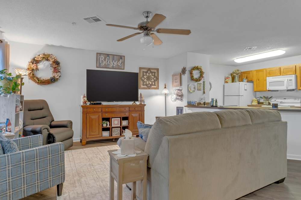 Modern living room with couch, chairs and ceiling fan at River Ridge in Sand Springs, Oklahoma