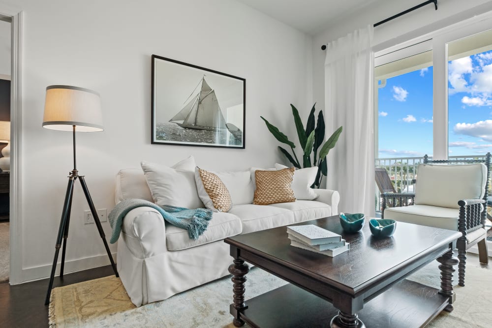 Well decorated model living room and private balcony at Oceanside Lantana in Lantana, Florida