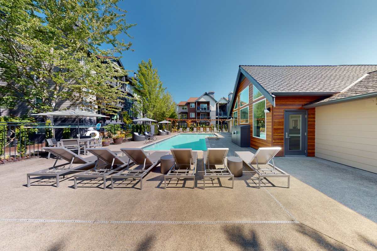 Swimming pool with lounge chairs at Redmond Place Apartments in Redmond, Washington
