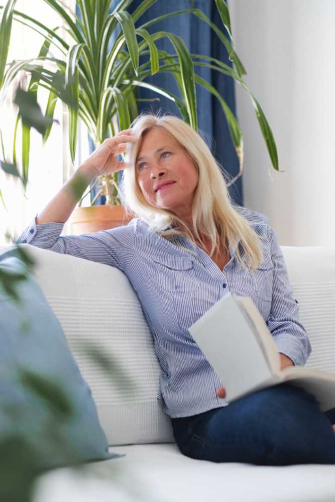 Resident relaxing and reading at La Jolla Place in El Paso, Texas