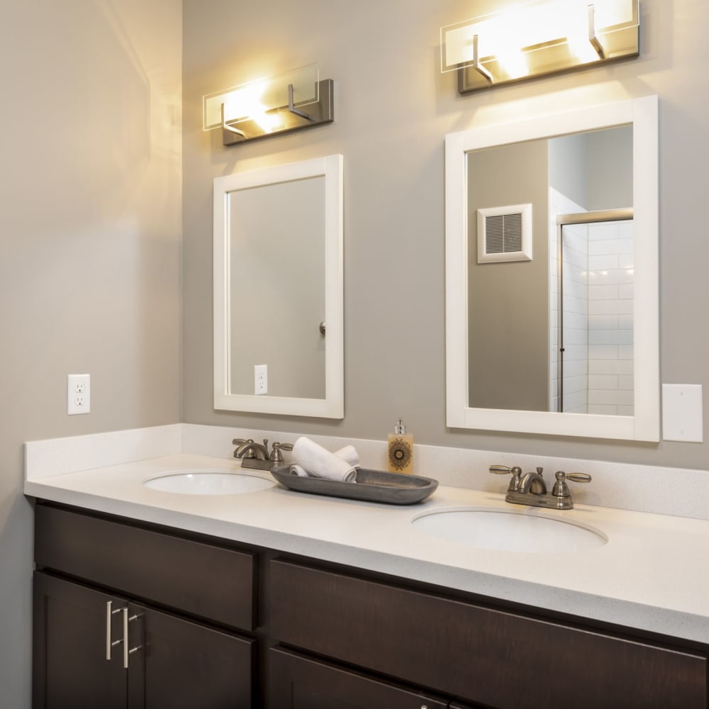 Bathroom with mirrors and plenty of lighting at Springhill Apartments in Overland Park, Kansas