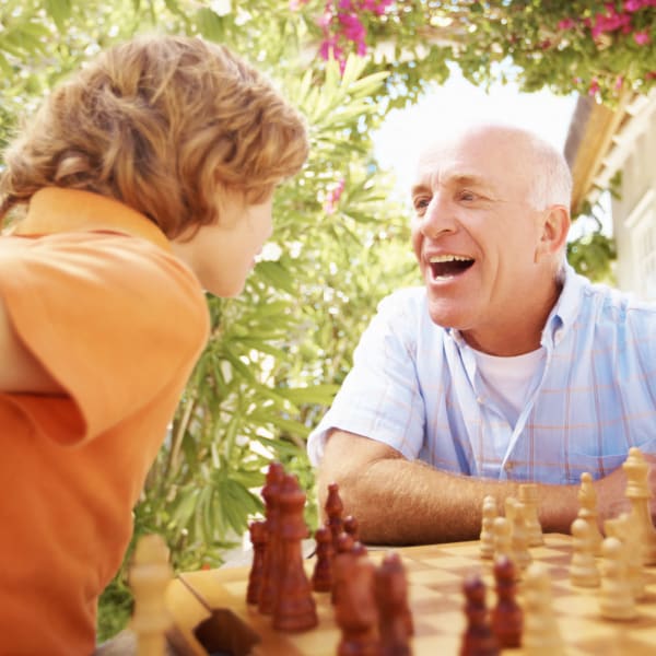 A man and his grandson playing chess at Kenmore Senior Living in Kenmore, Washington