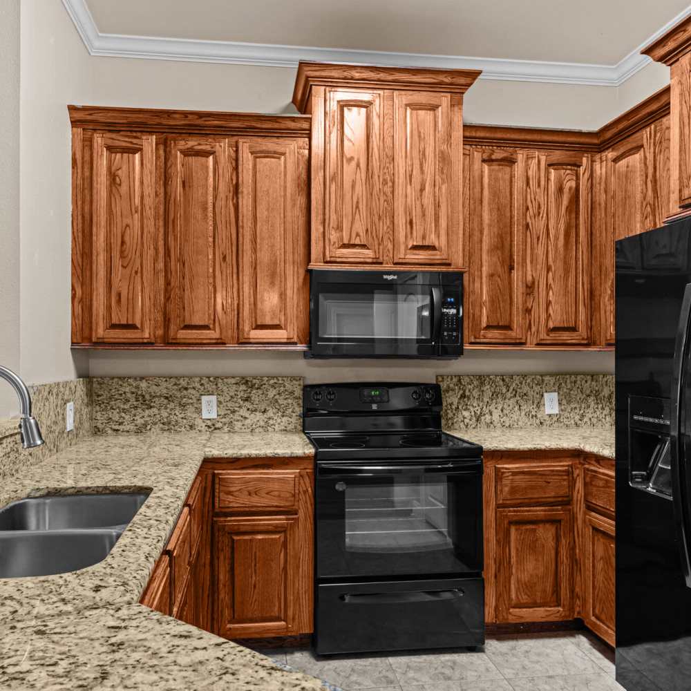 Kitchen with refrigerator at The Arbors of Mineola in Mineola. TX