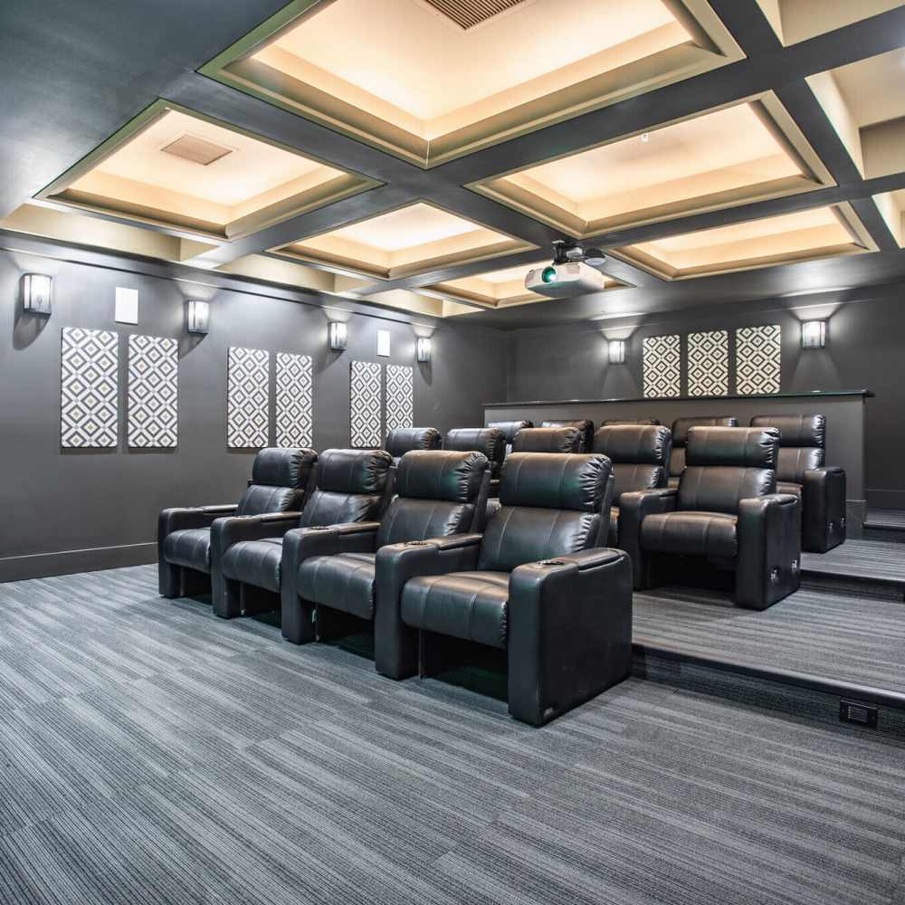 Home theater with plush seating and modern decor at The Apartments At Kelton Station in Williamsburg, Virginia
