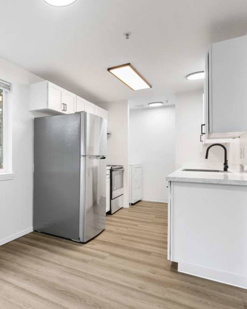 Furnished kitchen with wood-style flooring at Reedville Meadows in Beaverton, Oregon