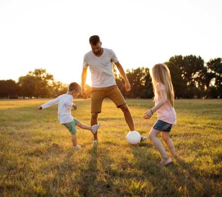 Resident playing with his kids near Terrace Garden Apartment Homes in San Leandro, California