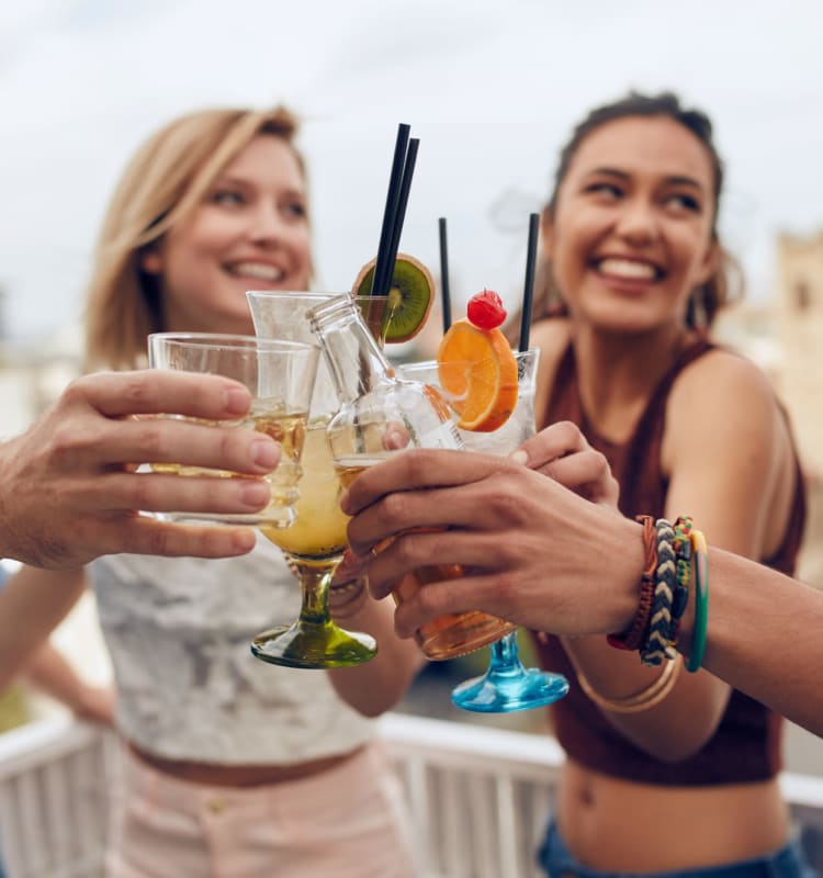 Friends having drinks on the patio of a bar near St. Tropez Apartments in Miami Lakes, Florida