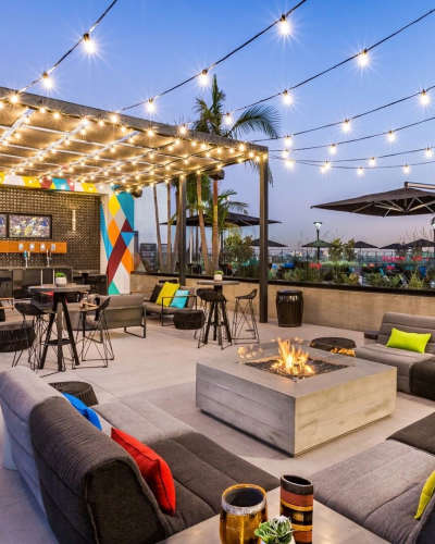 Patio with firepit and outdoor bar at The George Apartment Homes, Anaheim, California