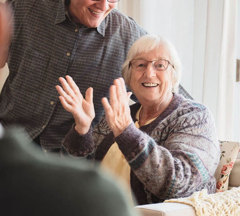 Resident laughing and clapping at Anthology of Wheaton in Wheaton, Illinois