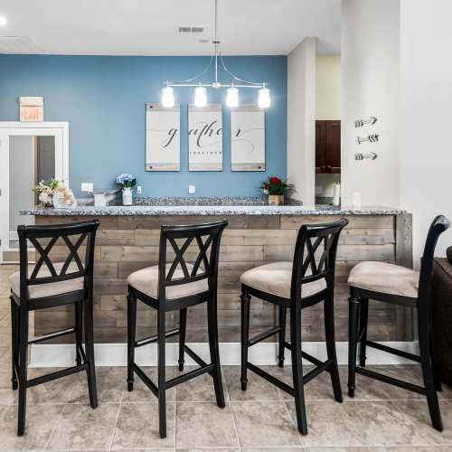 Clubhouse with kitchen and chairs at Brittany Place Hendersonville in Henderson, North Carolina