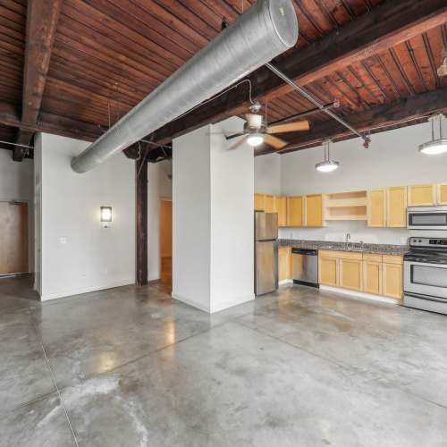 Unfurnished living room with view to open kitchen at Stadium Loft Apartments in Saint Louis, Missouri