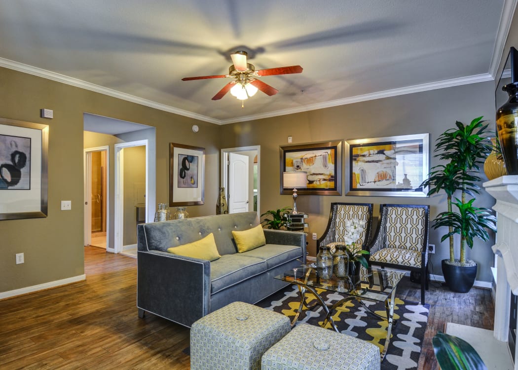 Well-decorated living room in open-concept floor plan of model home at San Paloma Apartments in Houston, Texas
