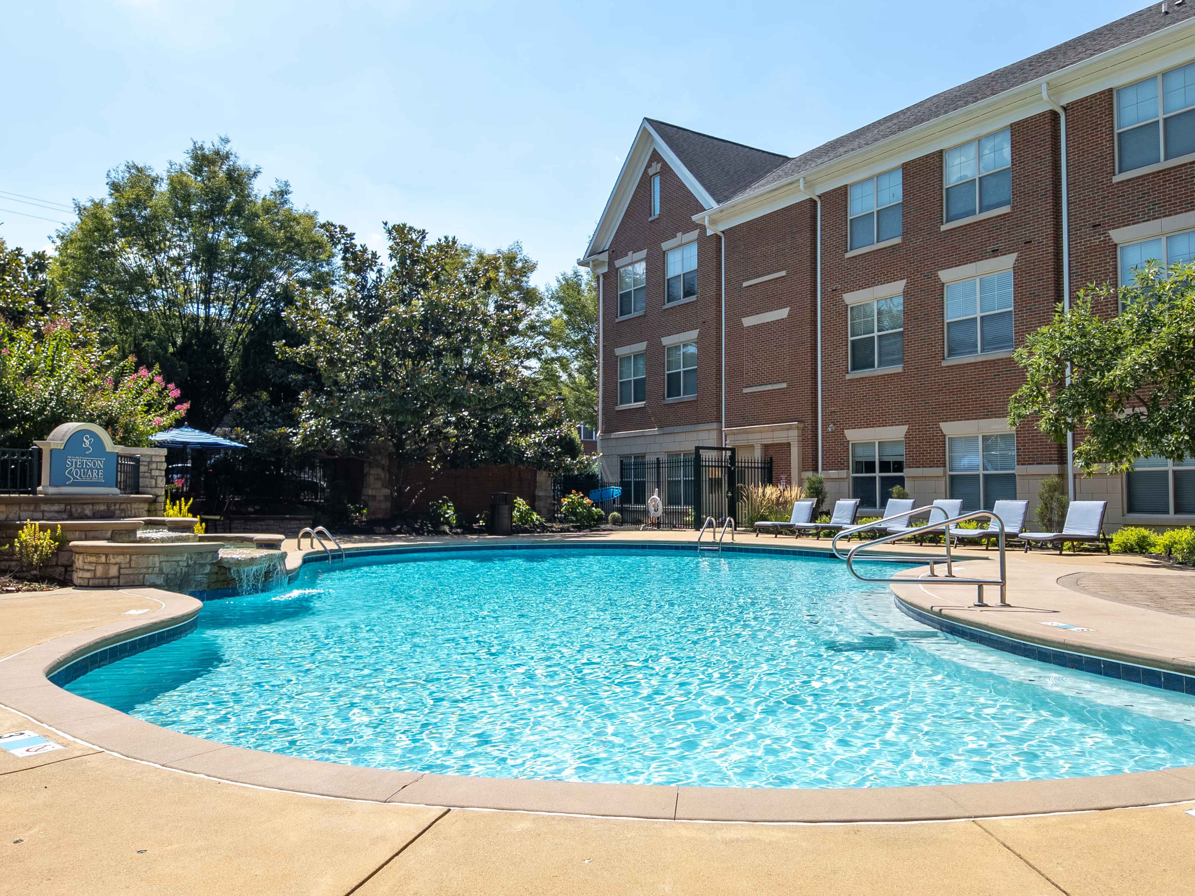 Sparkling swimming pool with waterfall at The Village at Stetson Square in Cincinnati, Ohio