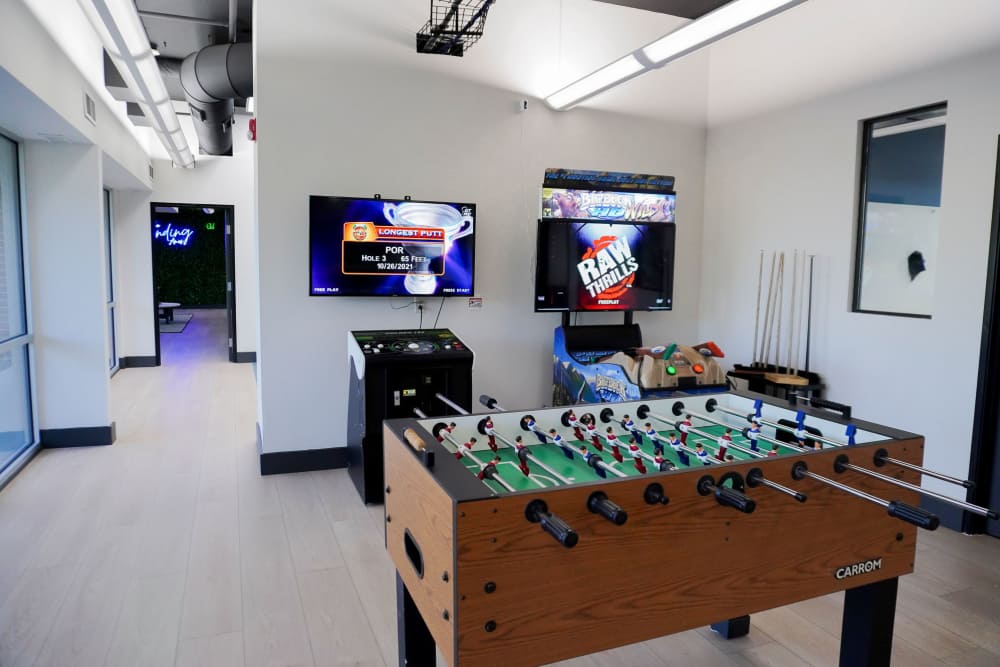 Game room with foosball and arcade games at The Landing Ames in Ames, Iowa