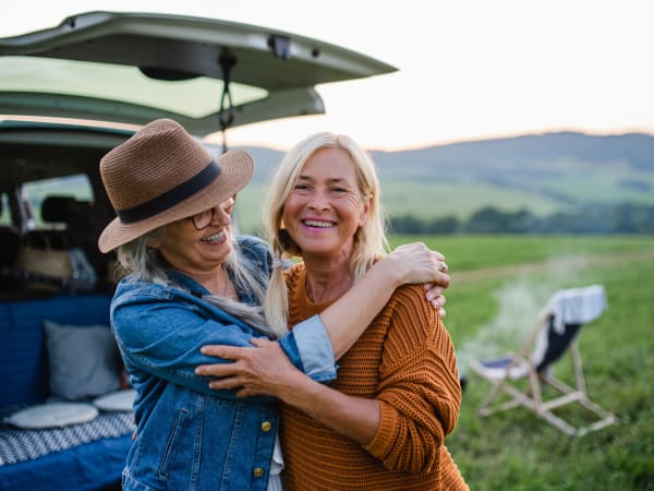 Two women embracing outside of a van near BestBox Storage - Villa Ridge in Villa Ridge, Missouri