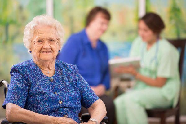 A woman resident sitting down at Heritage Senior Living and their signature programming.