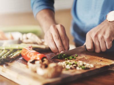 Resident chops vegetables for dinner at Marina Breeze in San Leandro, California