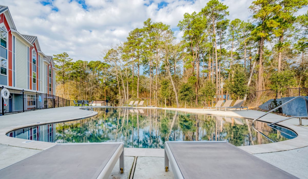 Apartment homes overlooking the pool at Huntsville Village Apartments in Huntsville, Texas