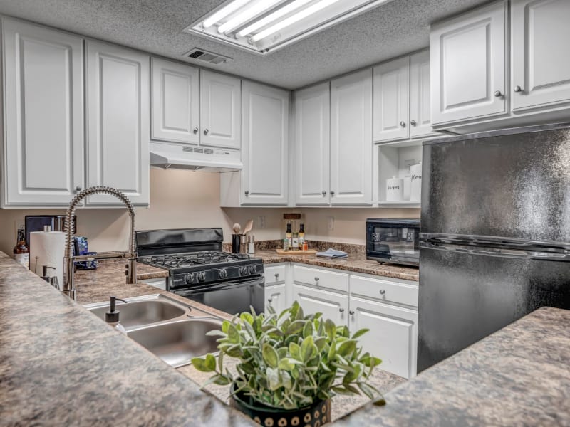 White cabinets in an apartment kitchen at Adrian On Riverside in Macon, Georgia