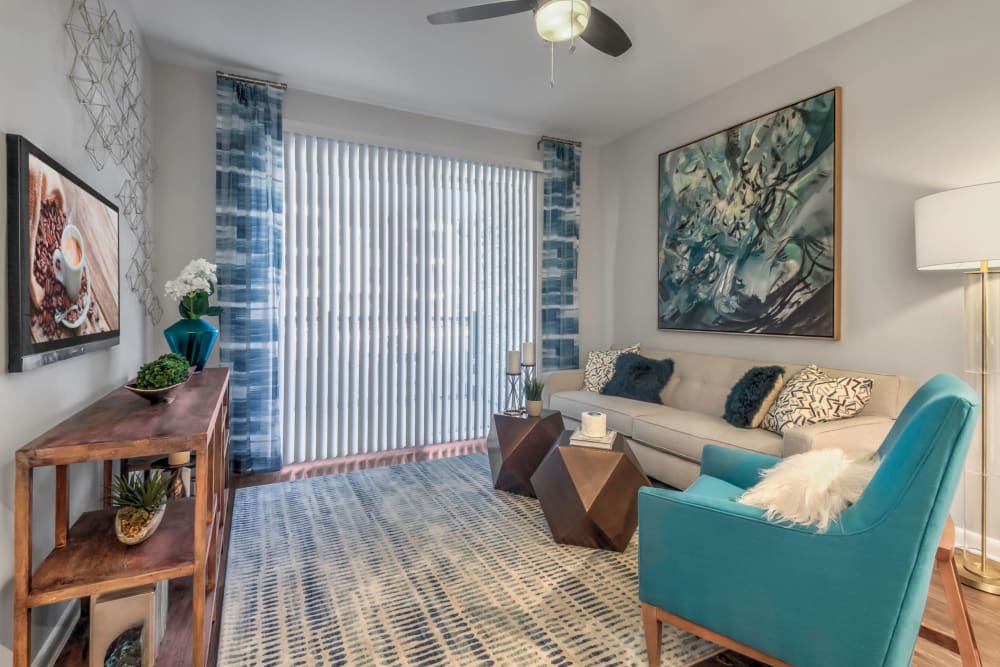 Modern decor and a ceiling fan in a model home's living area at The Palmer in Charlotte, North Carolina
