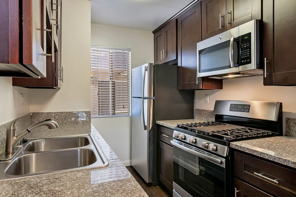 Kitchen with stainless-steel appliances at Kaitlin Court, Los Angeles, California