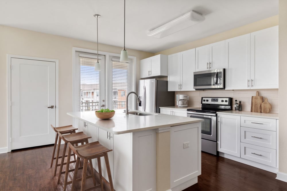 Model kitchen with a large island and quartz countertops at The Point at Town Center in Jacksonville, Florida